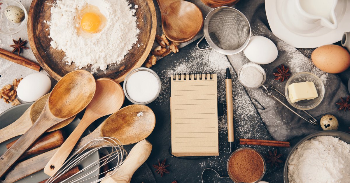 Overhead view of baking ingredients and a notepad